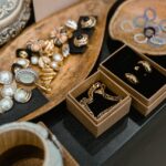 A sophisticated display of assorted jewelry pieces arranged on elegant wooden trays.